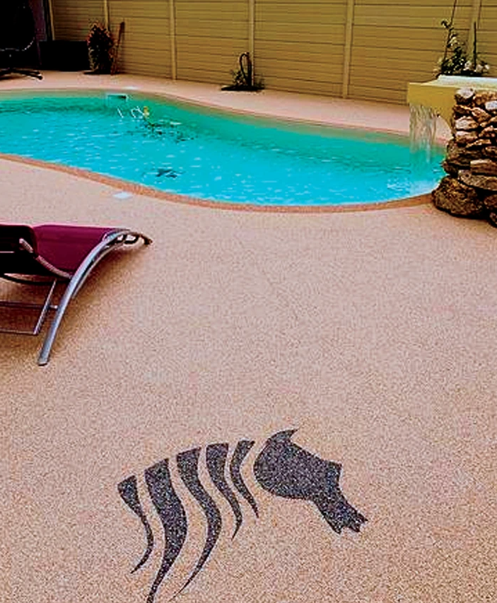 Exposed aggregate pool deck with decorative inlay