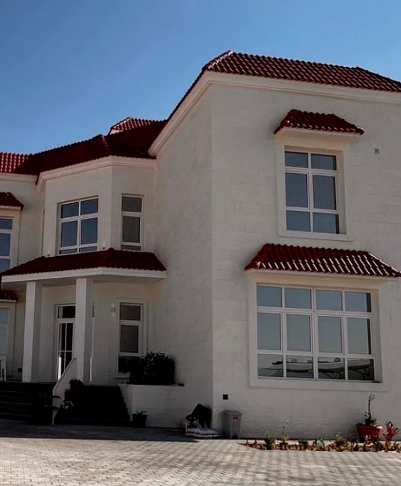 Villa exterior with stone finish and tiled roof